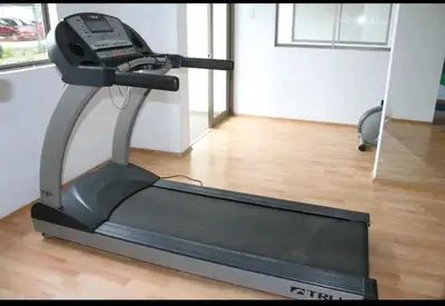 a treadmill in a room with a wooden floor at An apartment with an ocean view, near the airport in Lima