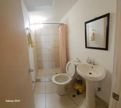 a bathroom with a toilet and a sink at An apartment with an ocean view, near the airport in Lima