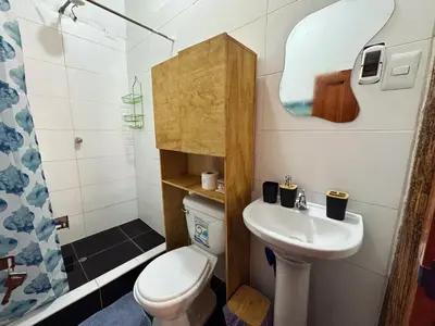 a small bathroom with a toilet and a sink at Casa Muyuna in Calca