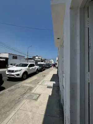 a white car parked on the side of a building at Casa playa Punta Hermosa in Punta Hermosa