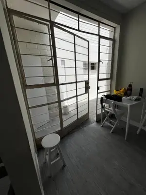 a room with a table and a table and a window at Casa playa Punta Hermosa in Punta Hermosa