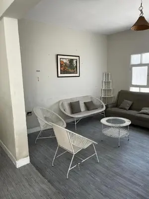 a living room with two chairs and a couch at Casa playa Punta Hermosa in Punta Hermosa