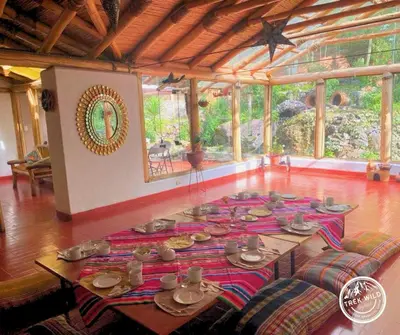 a room with a table with dishes on it at Hanaq Pacha Wasi in Calca
