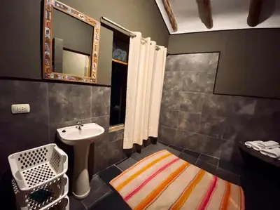 a bathroom with a sink and a mirror and a sink at Hanaq Pacha Wasi in Calca