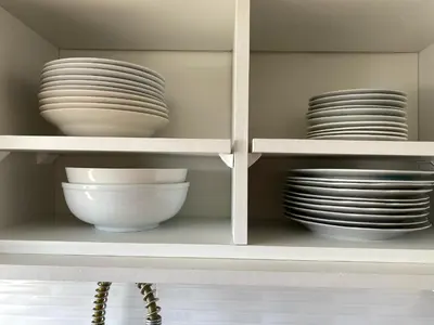 a white shelf with plates and bowls on it at Departamento con vistas al mar - Costa Lounge in Lima