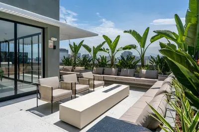a patio with couches and chairs on a building at S29 by Geko in Lima
