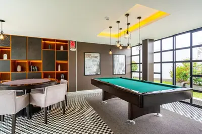 a billiard room with a pool table and chairs at Sunline 2BR by Geko in Lima