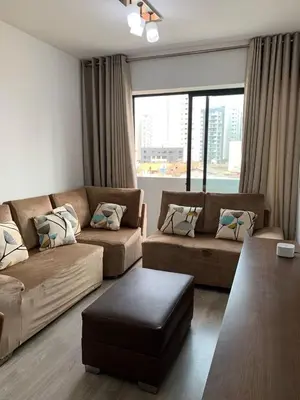 a living room with two couches and a large window at Departamento céntrico rodeado de áreas verdes in Lima