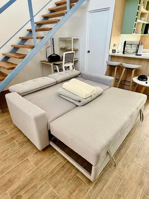a room with three beds and a staircase at Tiny House con Piscina Privada, AC and Starlink in Paracas