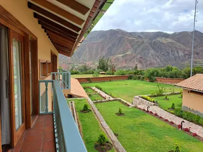 a balcony with a view of a yard at Casa Eva Hotel Boutique in Urubamba