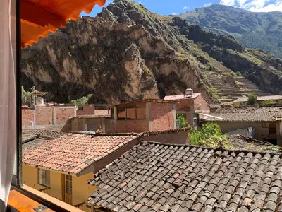 a view of a village with mountains in the background at Juliet's House in Ollantaytambo