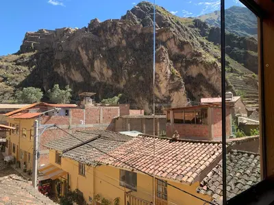a view of a city with a mountain in the background at Juliet's House in Ollantaytambo