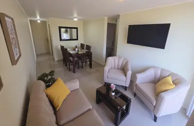 a living room with a couch and chairs and a table at Apartamento Premium frente a Universidad San Marcos para 4 pers en lima in Lima