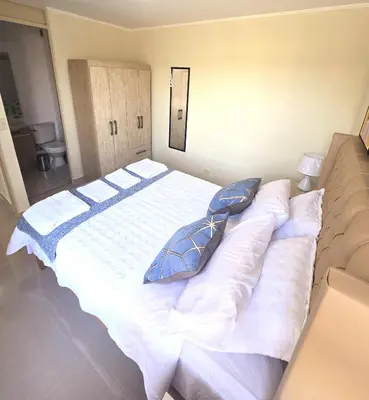 a bedroom with a large white bed with pillows at Apartamento Premium frente a Universidad San Marcos para 4 pers en lima in Lima