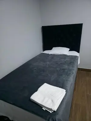 a bed with two white towels on top of it at Aero- apartamento in Lima