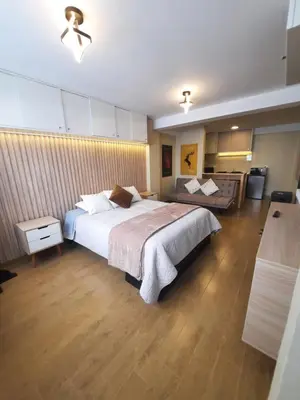 a bedroom with a large bed and a couch at Munay hospedaje in Cusco