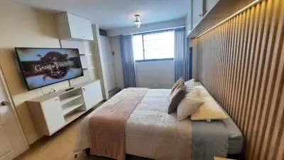 a bedroom with a large bed and a flat screen tv at Munay hospedaje in Cusco