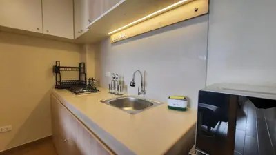a kitchen counter with a sink and a refrigerator at Munay hospedaje in Cusco