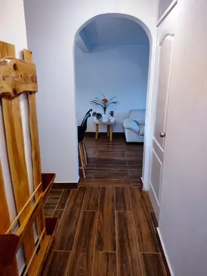 a hallway with wooden floors and an archway at Sweet Home Oxapampa in Oxapampa