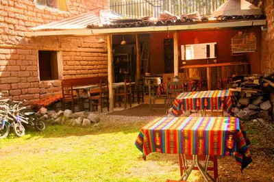 a chair with a colorful blanket sitting outside of a house at Hospedaje Pumayalli in Urubamba