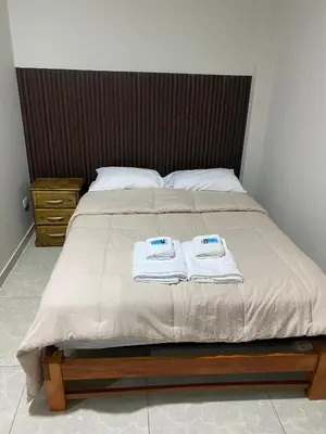 a bed with two towels on top of it at Mablia Suite in Ica