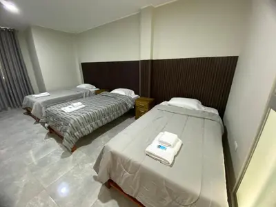 a hospital room with two beds in it at Mablia Suite in Ica