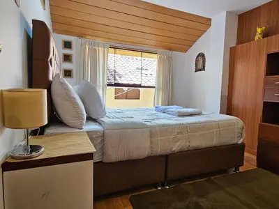 a bedroom with a large bed with a window at SAMAY WASI b&b in Cusco