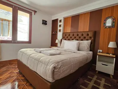 a bedroom with a large bed and a window at SAMAY WASI b&b in Cusco