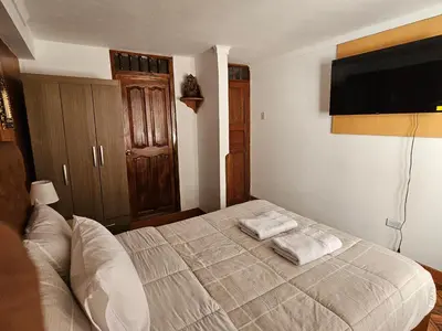 a bedroom with a bed with two towels on it at SAMAY WASI b&b in Cusco