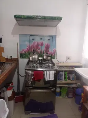 a kitchen with two pots on top of a stove at Apartment 12 min from airport in Lima