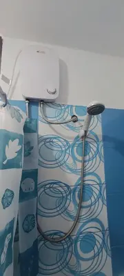 a bathroom with a hose hooked up to a wall at Apartment 12 min from airport in Lima