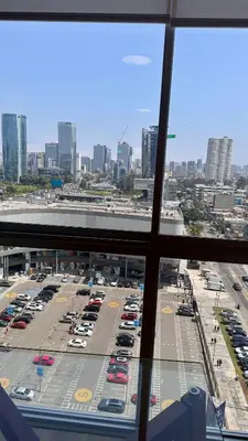 a view from a window of a parking lot with cars at Apartment in front of the Ricardo Palma Clinic in Lima