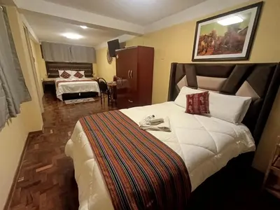 a hotel room with a large bed and a bedroom at The Culinary Stay and Taste in Cusco
