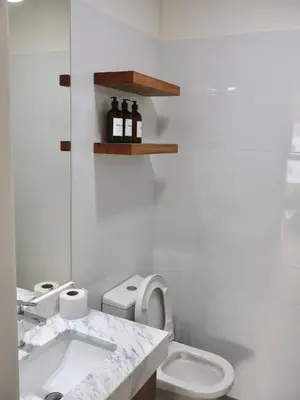 a white bathroom with a toilet and a sink at Craviz house ,a home away from home in Lima