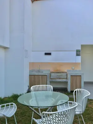 a table and chairs with a kitchen in the background at Craviz house ,a home away from home in Lima
