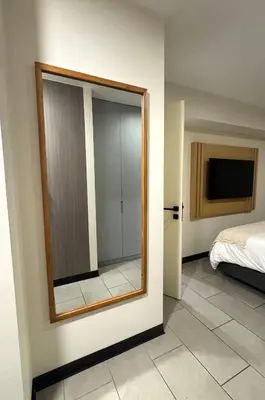 a mirror on a wall next to a bedroom at San Isidro 1 Bedroom RN in Lima