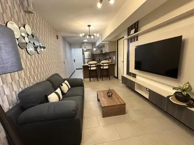 a living room with a couch and a flat screen tv at San Isidro 1 Bedroom RN in Lima