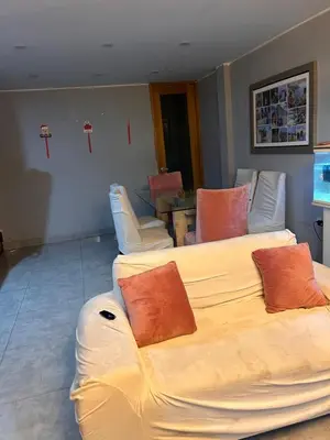 a living room with a couch with pillows on it at Departamento Palmeras in Lima