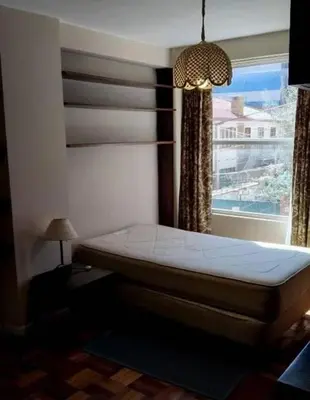a bedroom with a bed in front of a window at La casona cusco in Cusco