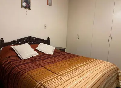 a bedroom with a large bed with two pillows on it at La casona cusco in Cusco