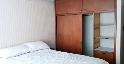 a bedroom with a bed and a wooden cabinet at La casona cusco in Cusco