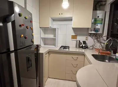 a kitchen with a stainless steel refrigerator with magnets at Apartment in cusco center in Cusco