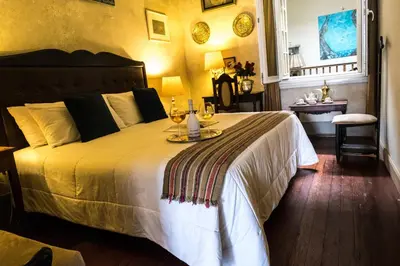 a bedroom with a bed with a tray of food on it at Casa Falleri Boutique Hotel in Lima