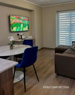 a living room with a couch and a table at Luxurious brand new apartment in Lima