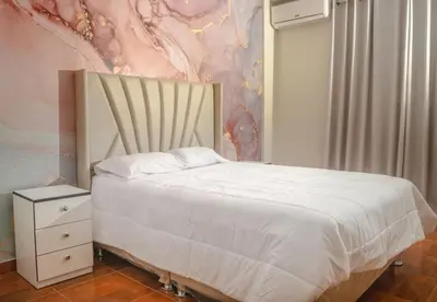 a bedroom with a bed and a dresser and a wall at Lovely Apartment-Punta Hermosa in Punta Hermosa