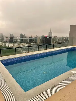 a large swimming pool on top of a building at Depa en Av Javier Prado frente a San isi in Lima