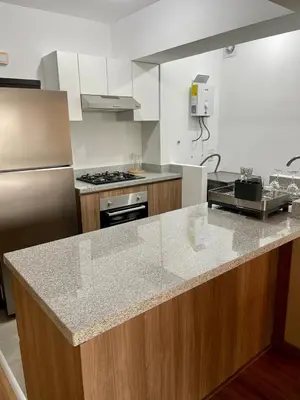 a kitchen with a counter and a stove top oven at Depa en Av Javier Prado frente a San isi in Lima