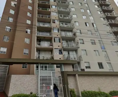 a person walking in front of a large apartment building at Varela Piso 12 in Lima