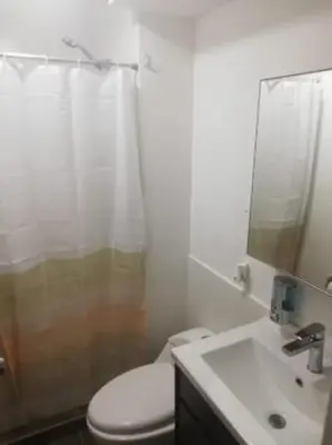 a bathroom with a toilet and a shower and a sink at Varela Piso 12 in Lima
