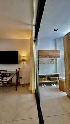 a living room with a tv and a table at Apartamentos Boho in Punta Hermosa